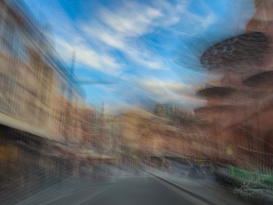 A warm brick canyon streaked beneath cloud, Sussex Street, Sydney, 2026, from the Sydney Streets series, an Intentional Camera Movement photograph by Jacky Lee